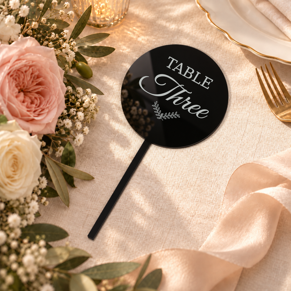 Black acrylic bouquet table number with Table Three personalization example, flat-lay wedding scene — digital product visualization; flowers, tableware and styling props not included.