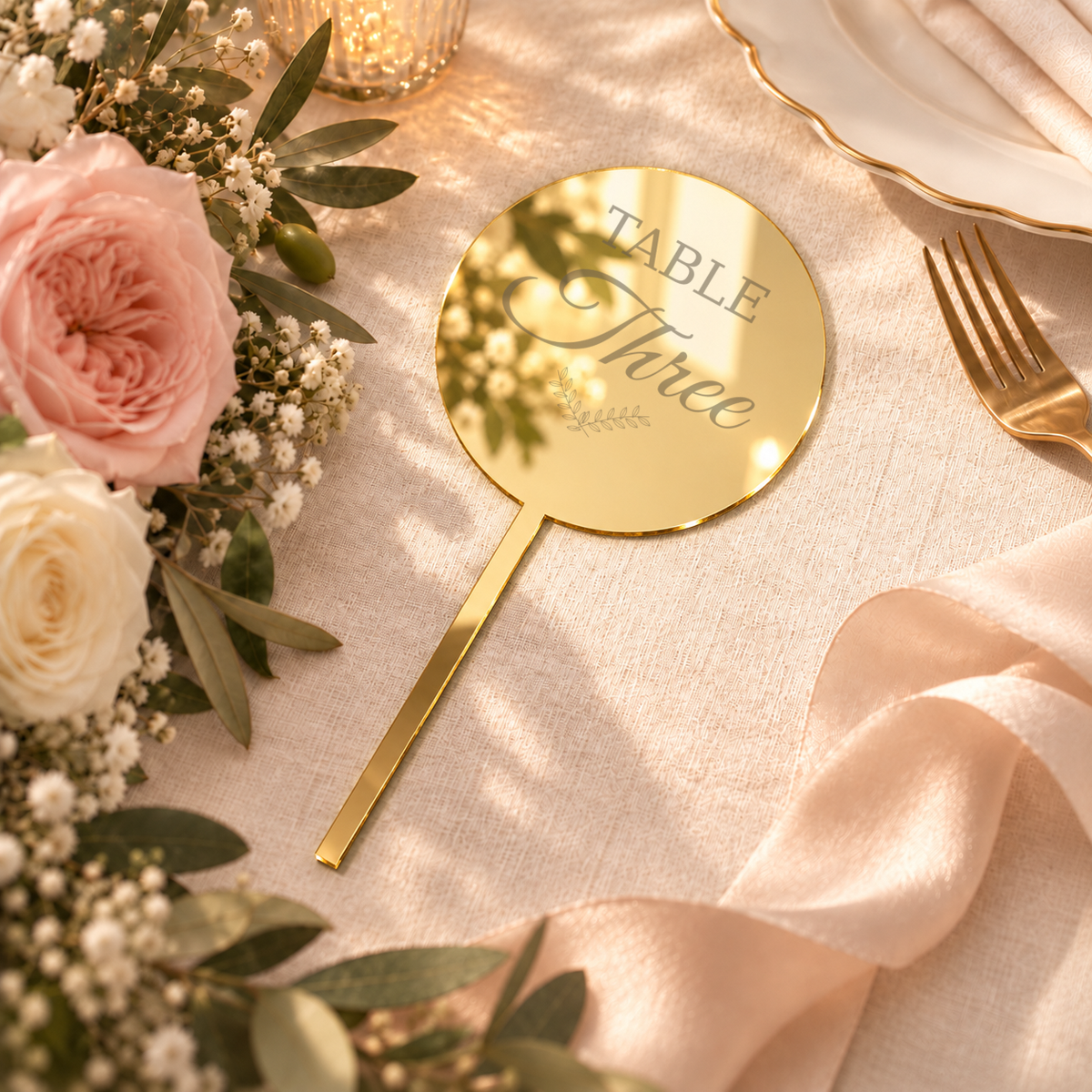Mirror Gold acrylic bouquet table number with Table Three personalization example, flat-lay wedding scene — digital product visualization; flowers, tableware and styling props not included.