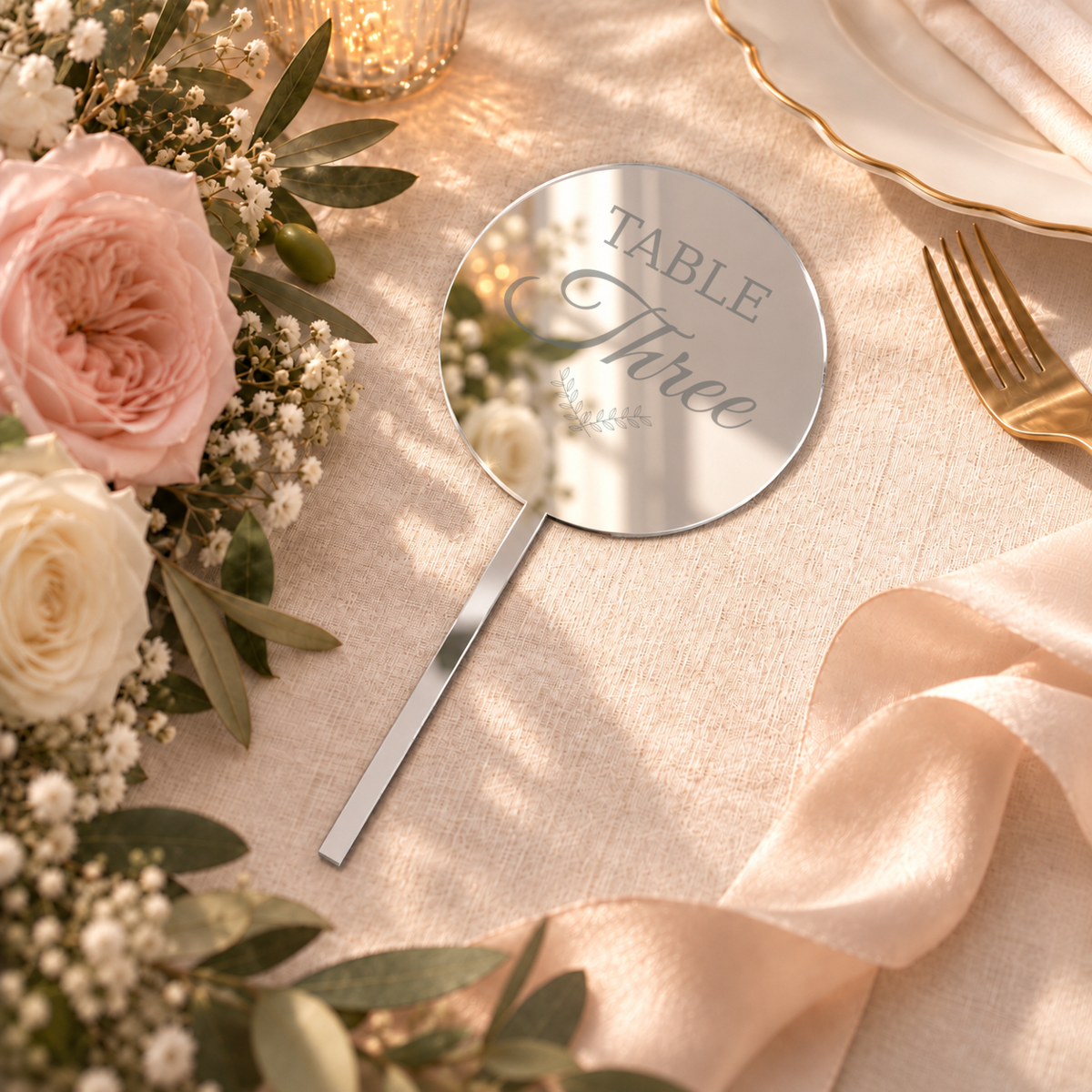 Mirror Silver acrylic bouquet table number with Table Three personalization example, flat-lay wedding scene — digital product visualization; flowers, tableware and styling props not included.