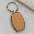 Close-up of the barrel-shaped wooden inset, polished silver-tone rim and attached split ring; generated visualisation based on real product photos