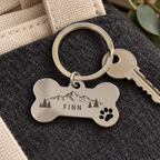 Silver bone keyring with sample Finn mountain engraving; house key is styling only