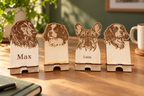 Four sample personalised wooden dog phone stands; price is for one stand. Digitally styled lifestyle image; props not included.