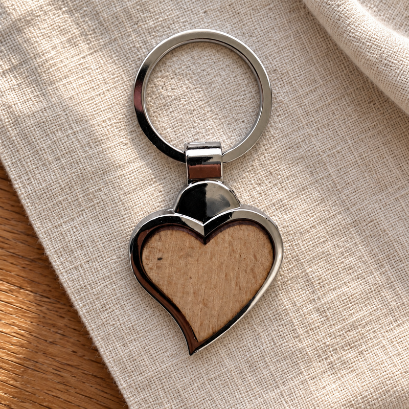 Heart wooden-inset metal keyring on neutral linen; photo-based generated visualisation, styling props not included