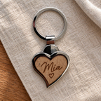 Mia name engraving example on wooden front; generated illustration, not a photographed finished sample