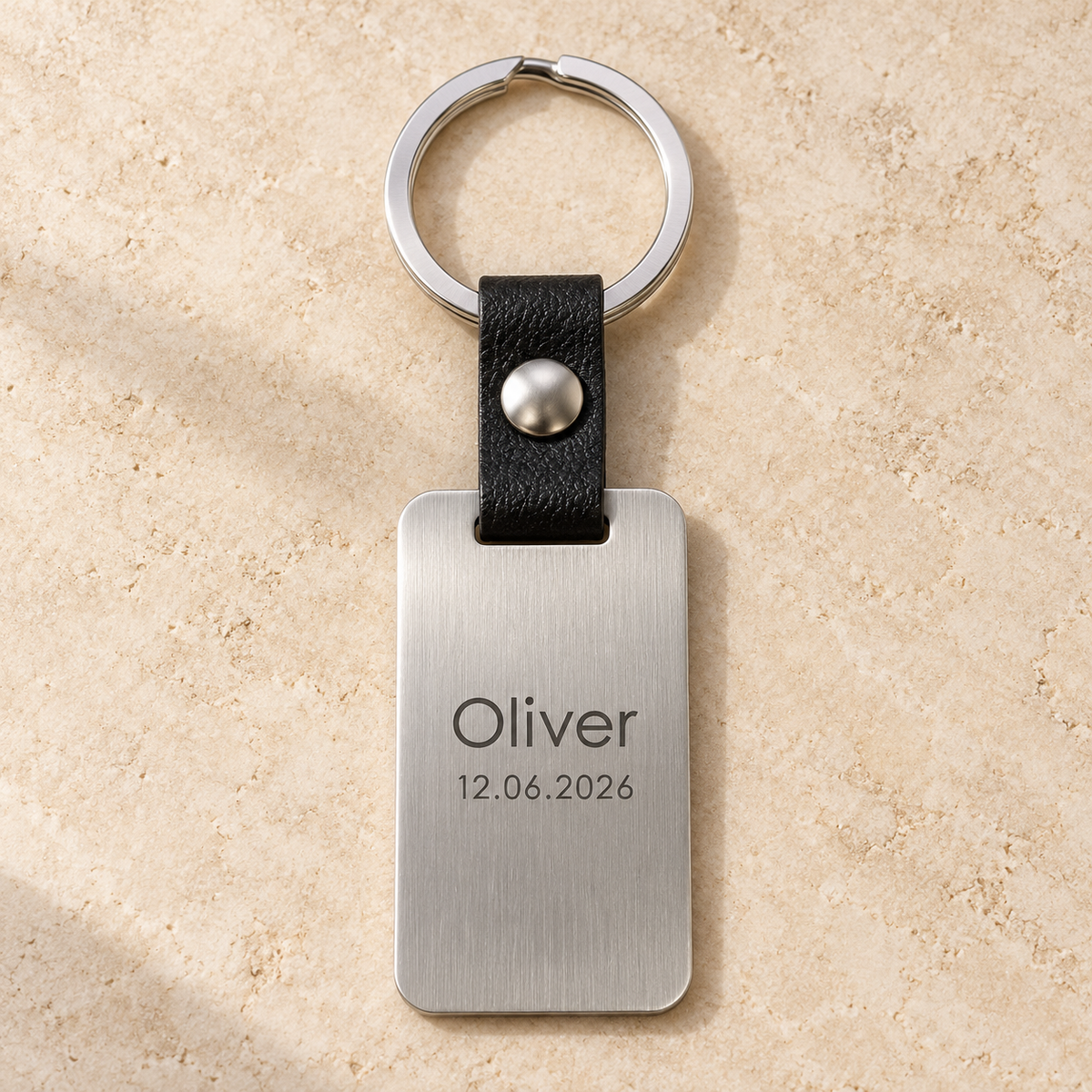 AI illustrative silver brushed stainless steel and black leather keyring: 02-name
