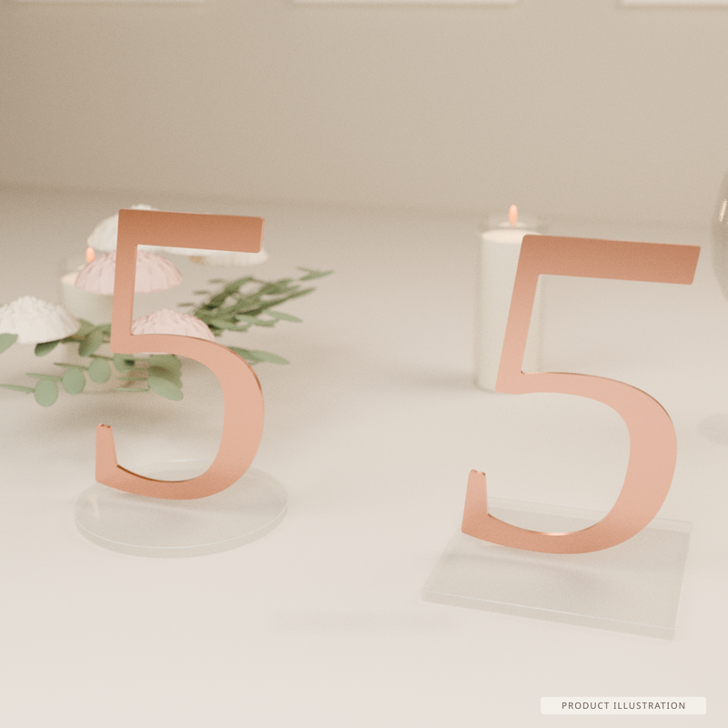 Wedding-table product illustration showing the same reinforced rose-gold numeral 5 with round and square clear acrylic base choices, styled with flowers and candles. Exact numeral artwork; base proportions and finishes illustrative, not a photograph or manufacturing/slot-fit proof.
