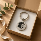 Dog portrait keyring in a kraft gift box with eucalyptus and ribbon on an oak table
