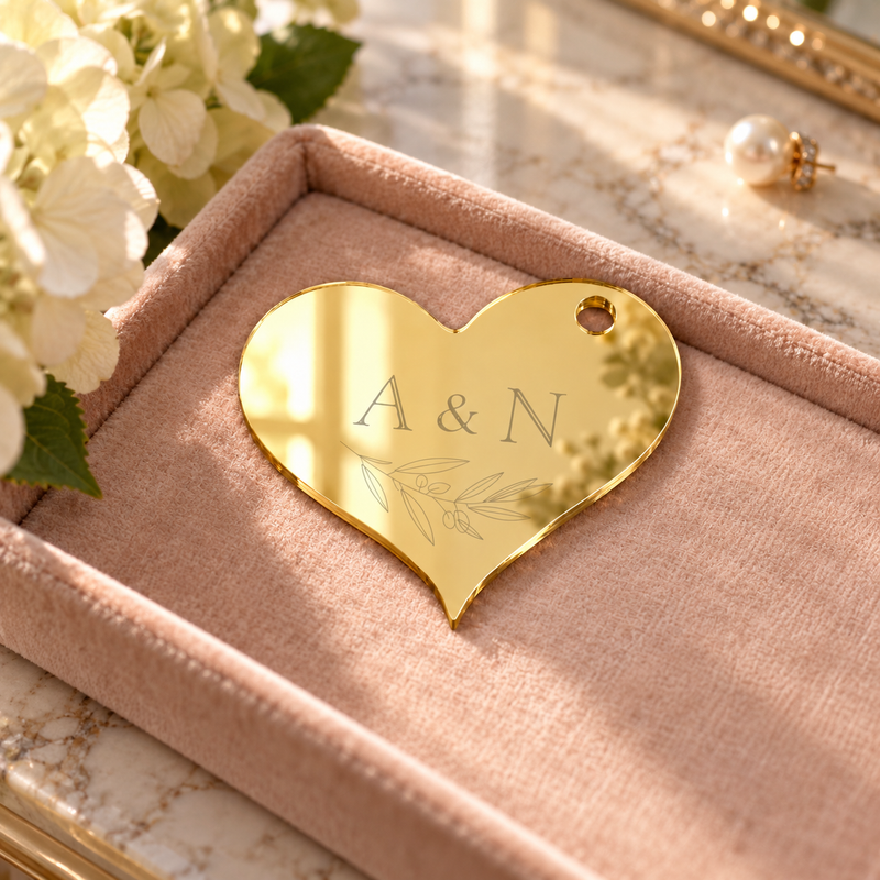 Personalised Mirror Acrylic Heart Wedding Gift Tags, Mirror Gold personalised example in a styled setting — digital scene visualisation. Selected tie option not shown; styling props not included.