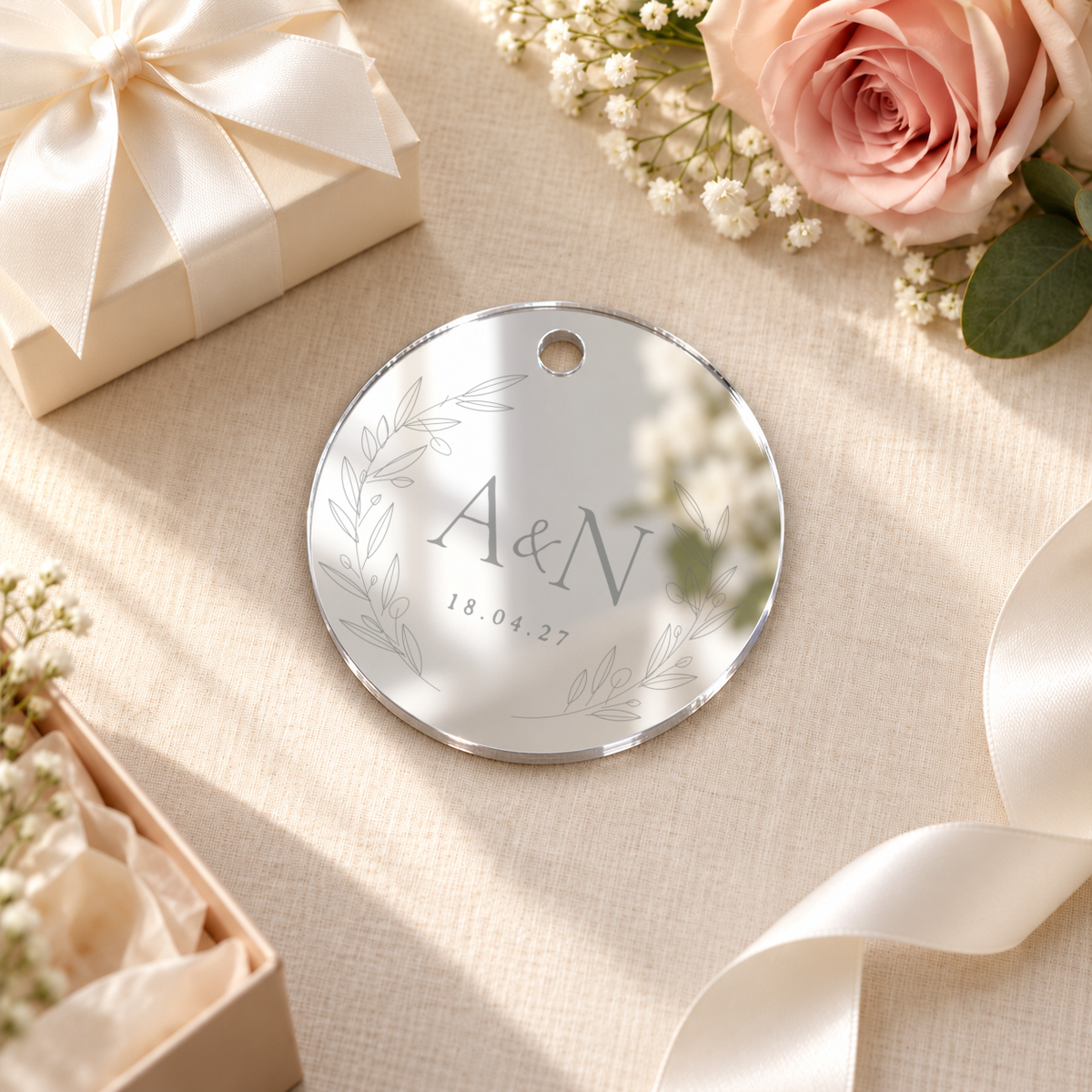Mirror Silver round acrylic wedding gift tag, personalized engraving example — digital scene visualization. Selected tie option not shown; styling props not included.
